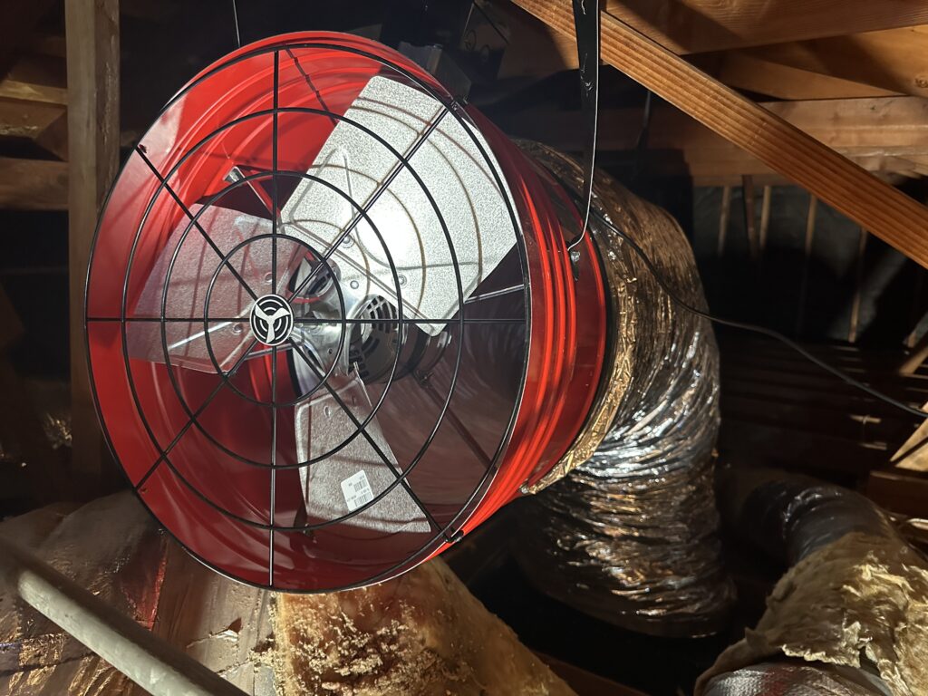 Red fan installed in attic space
