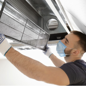 Person cleaning air conditioning filter.