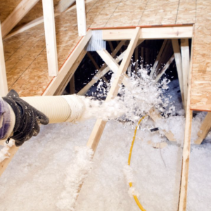 Insulation being blown into attic space