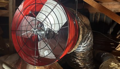 Red fan installed in attic space